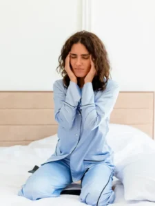 young-beautiful-woman-blue-pajamas-sitting-bed-touching-temples-having-storng-headache-bedroom-interior (1)